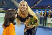 Kournikova recibe flores de una niñá de los Emiratos Árabes Unidos tras una exhibición