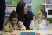 La reina Letizia conversa con dos de los alumnos del Gumersindo. FERNANDO OTERO