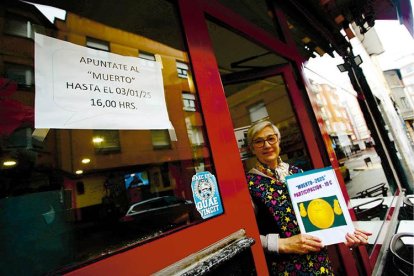 La responsable del bar Gómez de Ponferrada, ayer con el cartel «Apúntate al ‘Muerto’».
