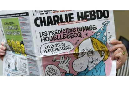 Un lector, con el número de la revista 'Charlie Hebdo'.