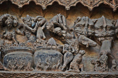 Relieves en piedra en la fachada principal de la Catedral de León donde los diablos meten en ollas hirviendo a aquellos que libremente decidieron darle la espalda a Dios.