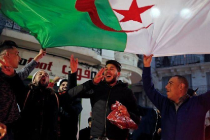 Un grupo de argelinos celebra en las calles de Argel la decisión de Buteflika de no volverse a presentar como candidato a la presidencia del país.