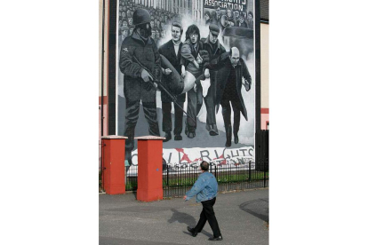 Un hombre camina frente al mural del «Bloody Sunday». STRINGER