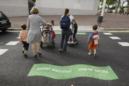 Madres con sus hijos, camino del colegio, en la Vila Olímpica.