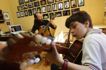 El profesor Israel Quintana en una clase de guitarra con un alumno