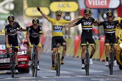 Froome, de amarillo, celebra la victoria en la entrada a la meta en París con todo su equipo.