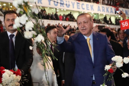 Erdogan da flores a sus seguidores a su llegada al congreso extraordinario del AKP, en Ankara, el 21 de mayo.