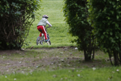 Un niño pasea con la bici por León durante el confinamiento. FERNANDO OTERO