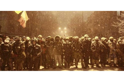Manifestantes proeuropeos bloquean una calle del centro de Kiev, en plena nevada, este lunes.