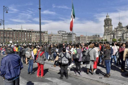 Personas desalojadas de edificios oficiales por el terremoto en Ciudad de México, este viernes.