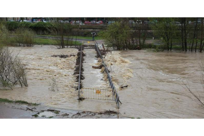 El abundante caudal del Bernesga a su paso por la capital leonesa y los escombros arrastrados por la corriente ocasionaron daños en las pasarelas.