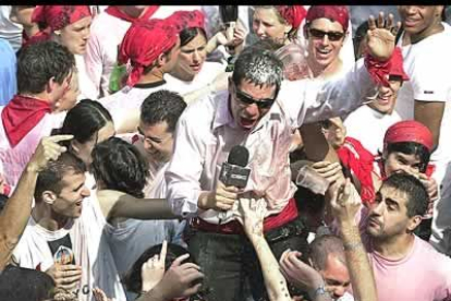 Un jóven parodia al presentador de un programa televisibo con el micrófono en mano mientras daba comienzo de forma oficial los siete días grandes de Pamplona.