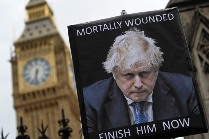 Imagen de un cartel con la imagen de Boris Johnson: «Herido de muerte». ANDY RAIN