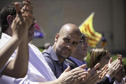 Pep Guardiola, entre Carles Puigdemont y Oriol Junqueras, este domingo, en la manifestación de la ANC, Òmnium y la AMI.
