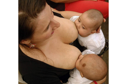 Una mujer amamanta a sus hijos en Medellín en una jornada de lactancia. LUIS EDUARDO NORIEGA