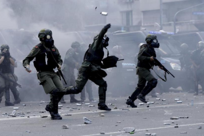 Policías lanzan botes de gas lacrimógeno contra los manifestantes que les lanzaron piedras y latas en las inmediaciones del Congreso, en Buenos Aires, el 14 de diciembre.