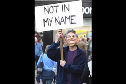 Un manifestante disfrazado con la máscara del Primer Ministro británico, Tony Blair, porta una pancarta con el lema 'Not in my name' ('No en mi nombre').