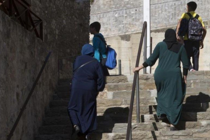 Dos madres acompañan a sus hijos al colegio en Ripoll, el pasado lunes.