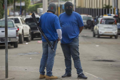 Dos seguidores de Daniel Ortega armados y con la cara tapada en la ciudad de Masaya. JORGE TORRES