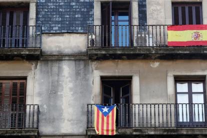 Una estelada y una bandera de España, en balcones de Barcelona.
