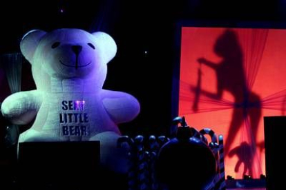 El decorado representaba una sala de juguetes con un oso de peluche rosa gigante con la inscripción i>Sexy Little Bear, grandes cajas de regalos y palitos de caramelo.