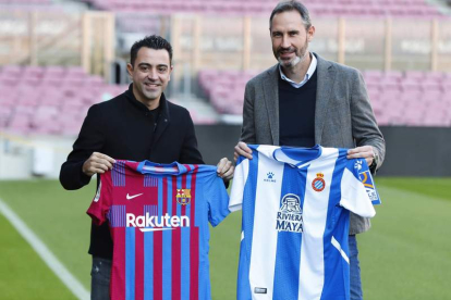 Xavi Hernández y Vicente Moreno posan con las camisetas del Barça y el Espanyol. ALEJANDRO GARCIA