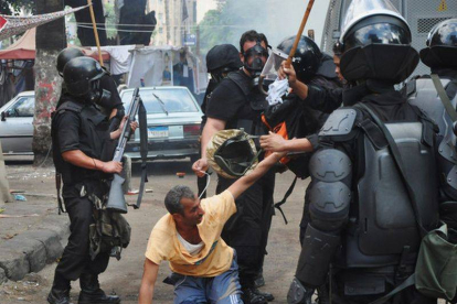 Imagen de las fuerzas de seguridad deteniendo a un simpatizante de Mohammed Mursi el 14 de agosto de 2013.