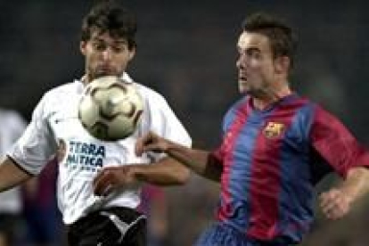 Marc Overmars controla la pelota en presencia del valencianista Ayala, durante el partido de ayer