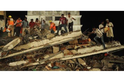 Personal de rescate y residentes del lugar buscan supervivientes bajo los escombros, el jueves por la noche en Thane.
