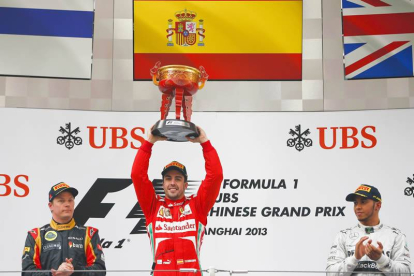 Fernando Alonso levanta el trofeo conseguido por su victoria en el Gran Premio de China.