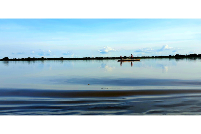 El río Congo en calma como un plato plateado y una de las miles de canoas que lo surcan a diario. MANUEL FÉLIX