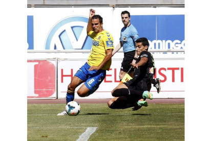 El defensa de la Unión Deportiva Las Palmas Angel López pelea un balón con el centrocampista del Córdoba Miguel Angel Nieto.
