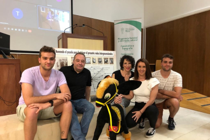 Las profesoras del programa intergeneracional del campus posan junto a César Corral y los dos nietos de 'Fariñas' que estudian Fisioterapia, junto al mural y un burrito de fieltro como el que empleaba el fotógrafo. CORTESÍA DE BEATRIZ ALONSO