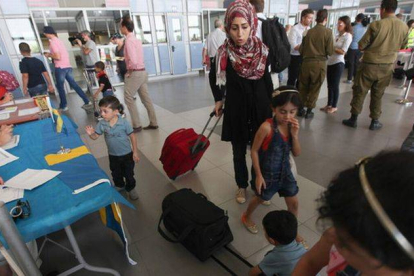 Palestinos con doble nacionalidad abandonan Gaza en el puesto fronterizo de Erez, este domingo.