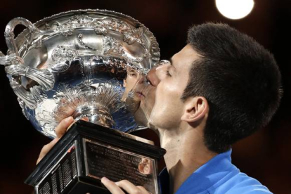 Novak Djokovic besa el trofeo que le acredita como campón del Abierto de Australia.