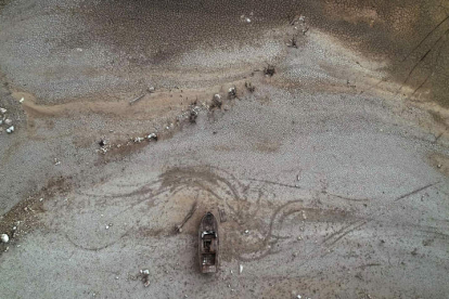 Imagen tomada desde un dron de una barca sobre la superficie seca de la tierra del pantano de Yesa. JESÚS DIGES