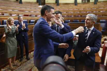Pedro Sánchez, reelegido presidente del Gobierno por mayoría absoluta este jueves en el Congreso recibe la felicitación de Fernando Grande Marlaska. HIDALGO