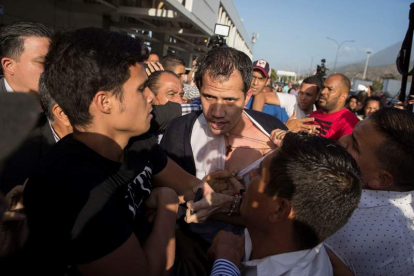 Un manifestante descamisa a Guaidó.