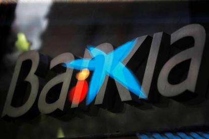 Fotografía de multiexposición que muestra los logotipos de las entidades bancarias Bankia y CaixaBank. JUAN CARLOS HIDALGO