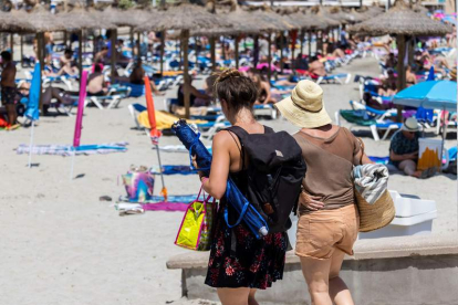Turistas disfrutando del sol en una de las playas de Mallorca. CATI CLADERA