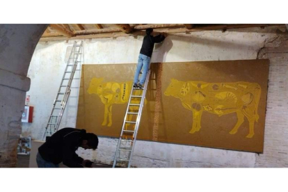 Montaje de la obra ‘El Dorado’ (1994), cedida por la familia de Arroyo, en la panera del monasterio de Sandoval. luis garcía