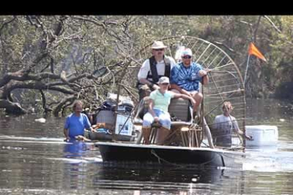 Trabajadores de rescate de varios estados y agencias se trasladan por la zona pantanosa en un bote impulsado por aire, en Matarie, en la zona de Jefferson Parish, Luisiana.
