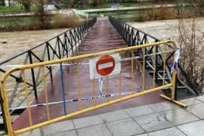 El Ayuntamiento de León ha cortado las pasarelas peatonales del río Bernesga por peligro de desbordamiento de río. RAMIRO