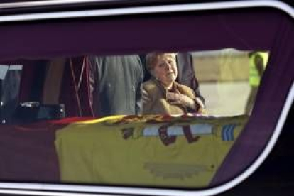 La madre del agente Fernando Trapero mira con dolor el féretro de su hijo a su llegada a Madrid