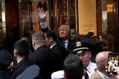 Trump saluda a sus seguidores desde la Trump Tower.