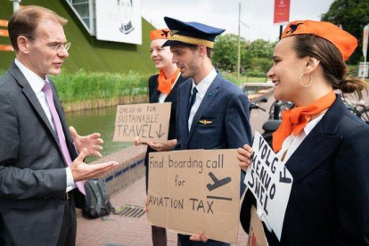 Activistas ambientales abordan a los participantes de la conferencia de La Haya sobre nuevos impuestos a la aviación.
