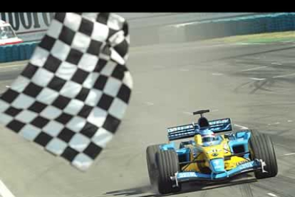 Momento en el que la bandera señala en fin de la carrera en la que Fernando Alonso consiguió el primer puesto.
