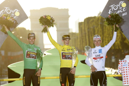 Jonas Vingegaard, con el maillot amarillo de campeón, junto a Van Aert y Pogacar. GARNIER ETIENNE