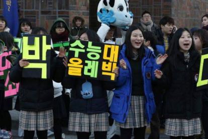 Un grupo de jóvenes anima los examinados en las pruebas de acceso a la universidad en Corea del Sur.