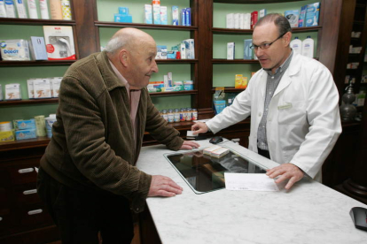 Un cliente recibe sus medicamentos por receta electrónica. LUIS DE LA MATA